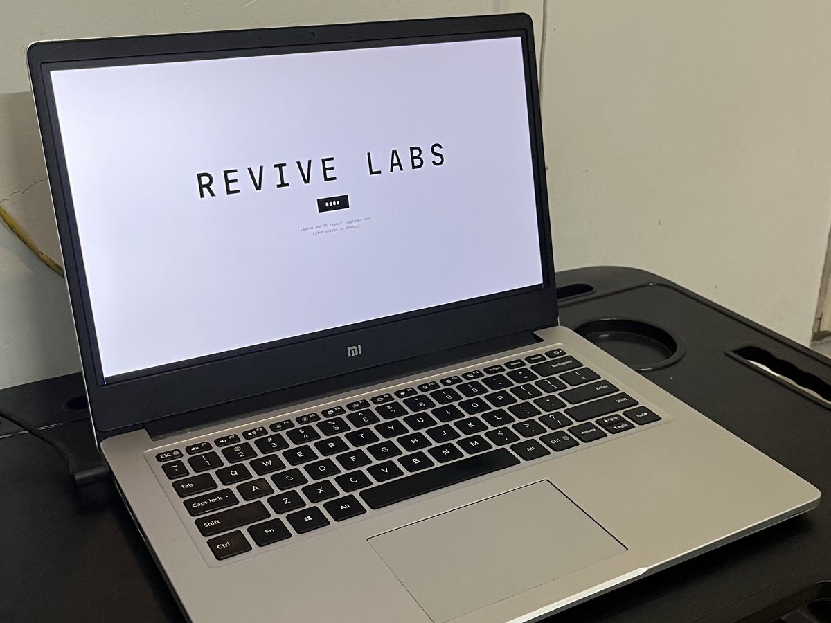 Mi Notebook laptop open on a desk, showing the Revive Labs website